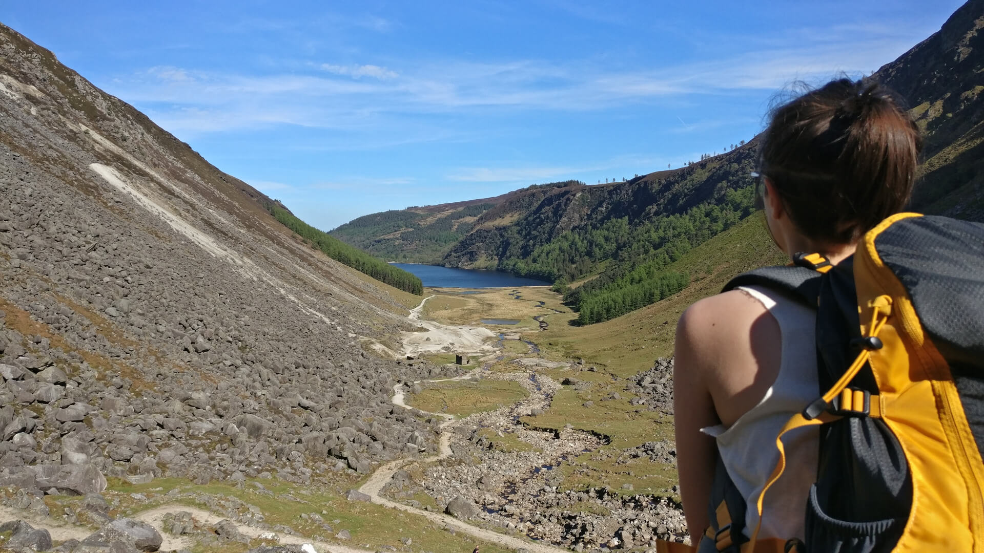 Alexandra Pedro on top of a hill looking into Glendalough, Ireland